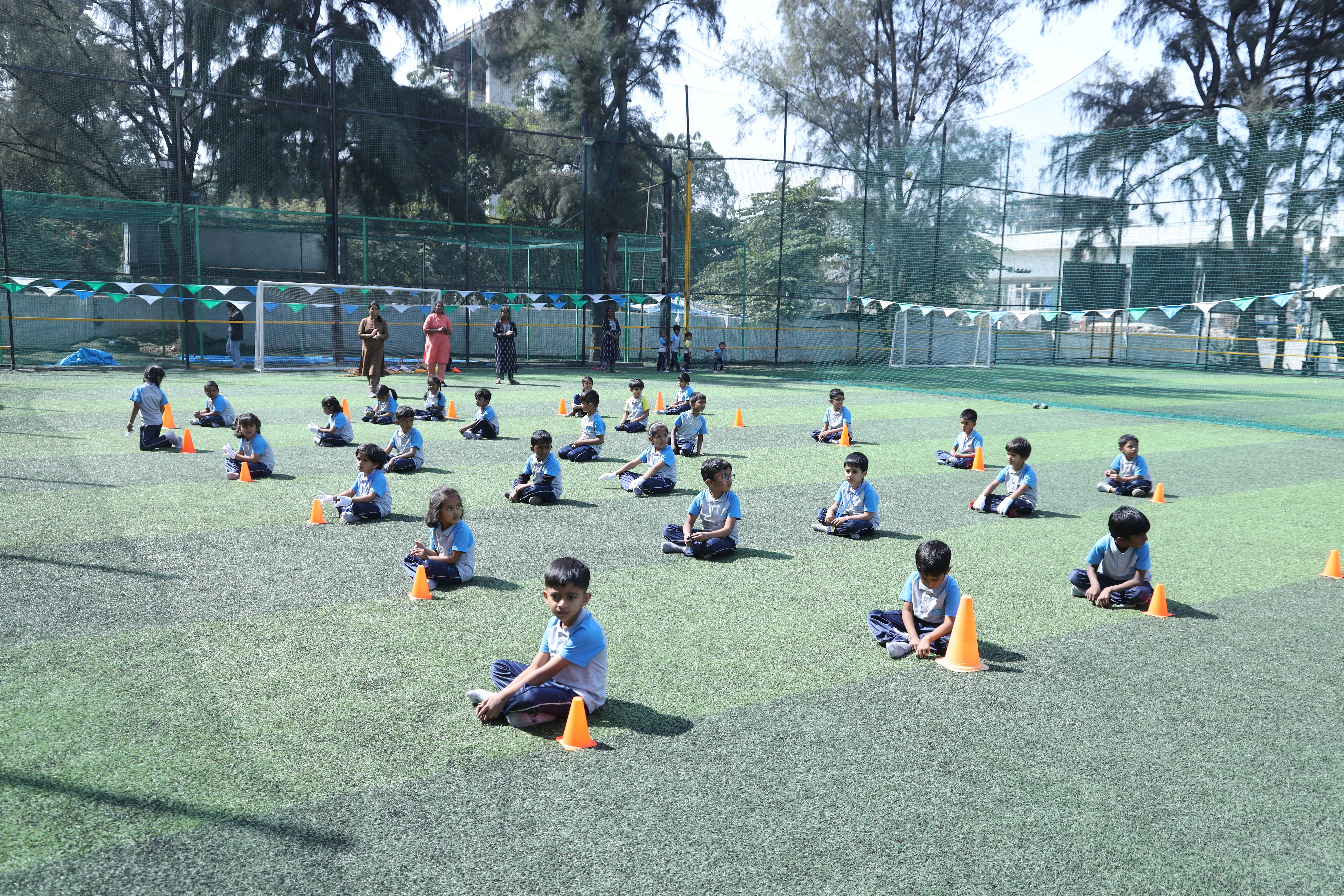 Children sitting among cones