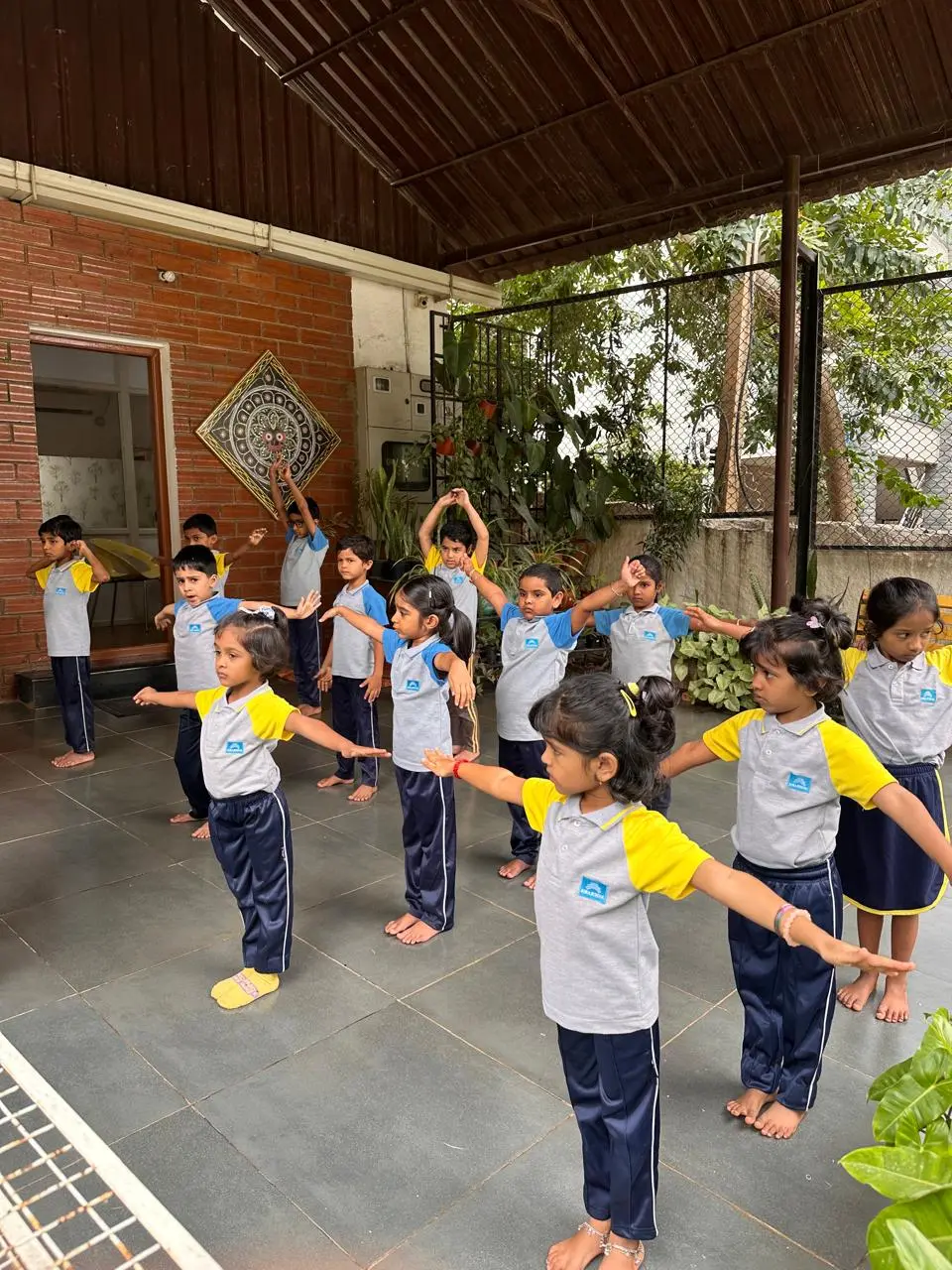 Children doing morning exercises together at Adra